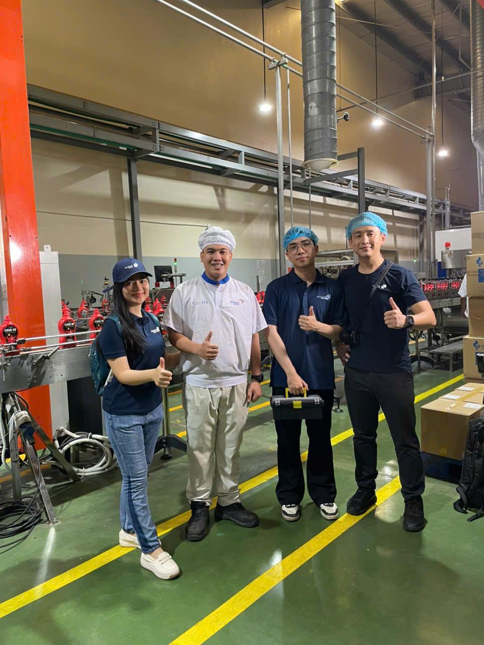 Thao (left) alongside her colleagues at work today
